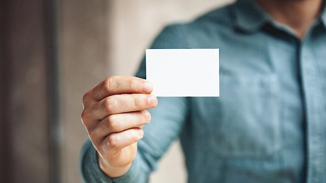 Man showing white business card